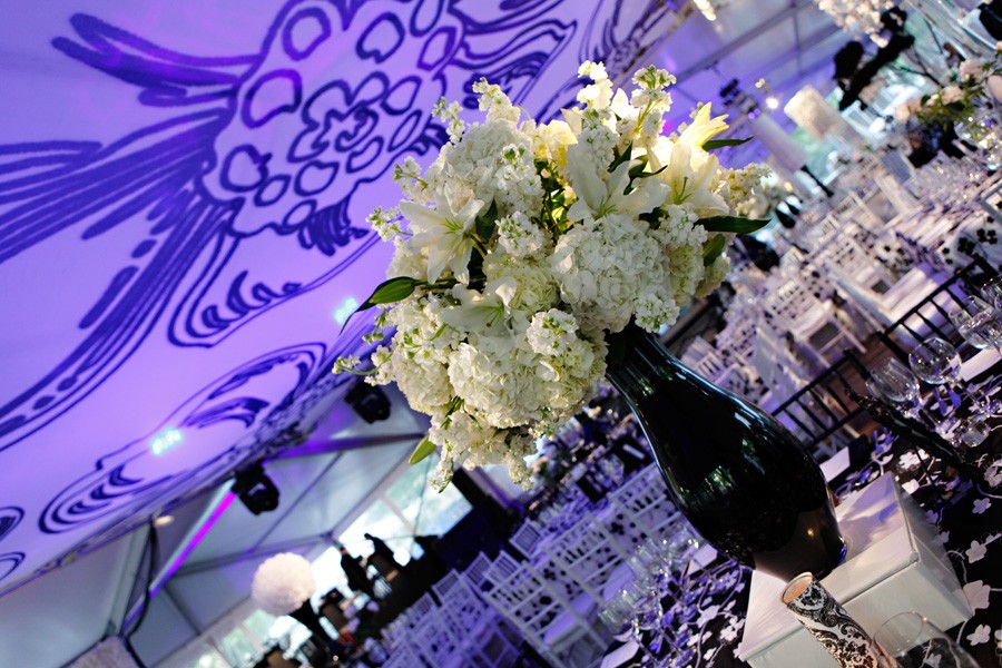 black vase with white flowers dogwood ceiling treatment purple lighting evantine design tented event