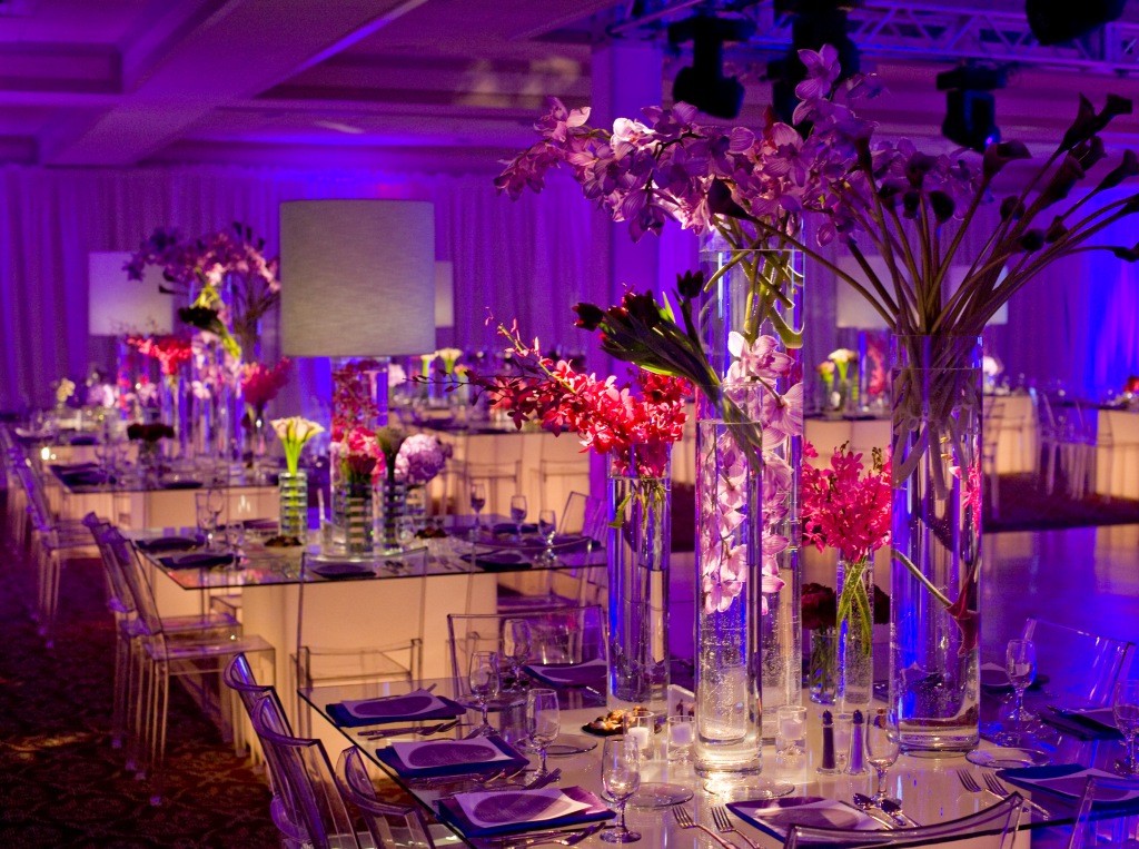 room shot purple lighting light up glass tables clear chairs purple flowers bat mitzvah melissa paul