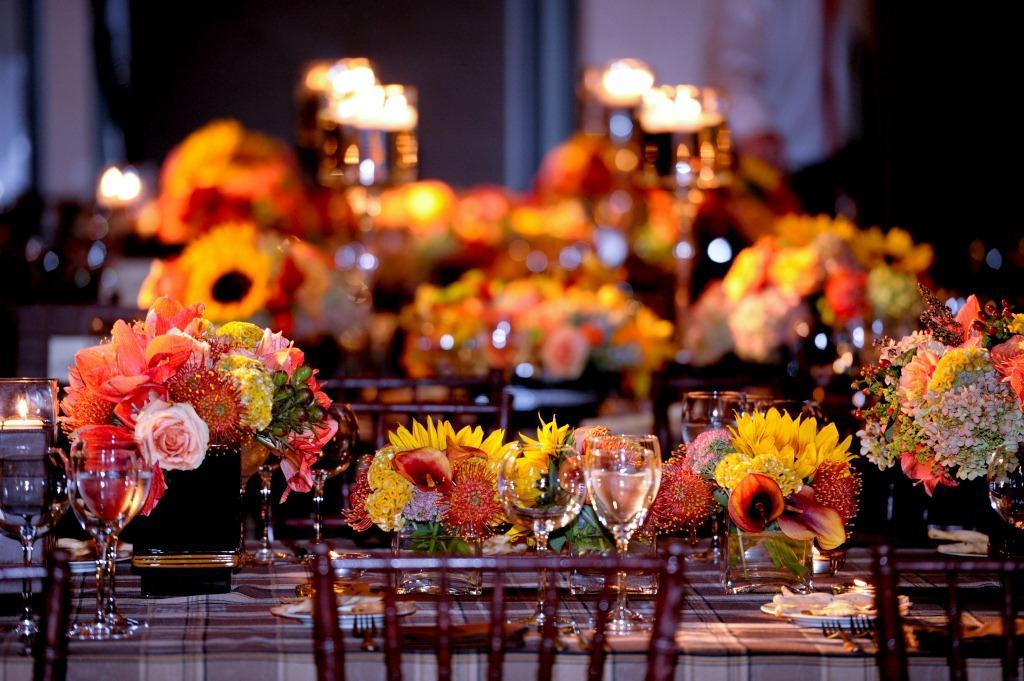 fall orange flowers for party centerpieces plaid linens brown chairs evantine design