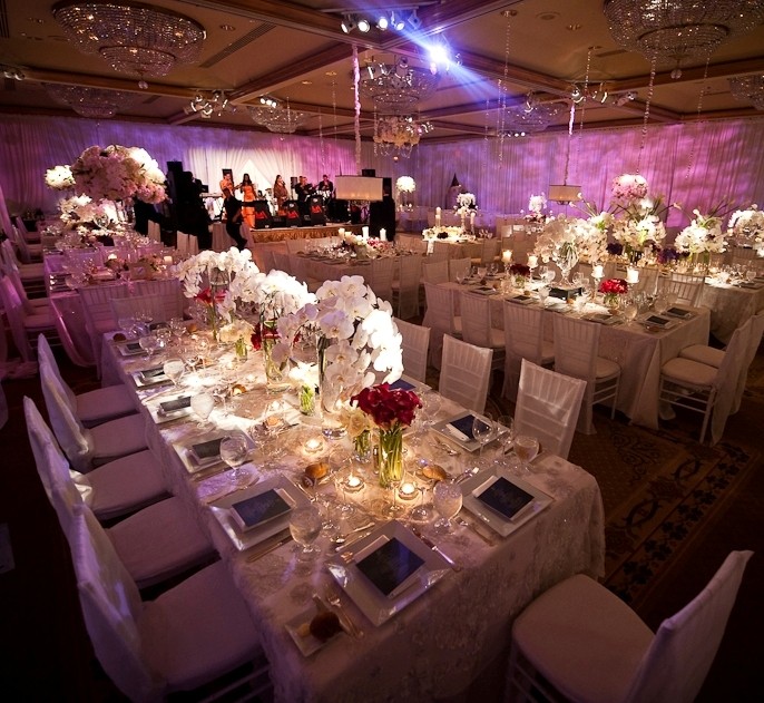 purple lighting in ballroom, suspended lampshades over tables
