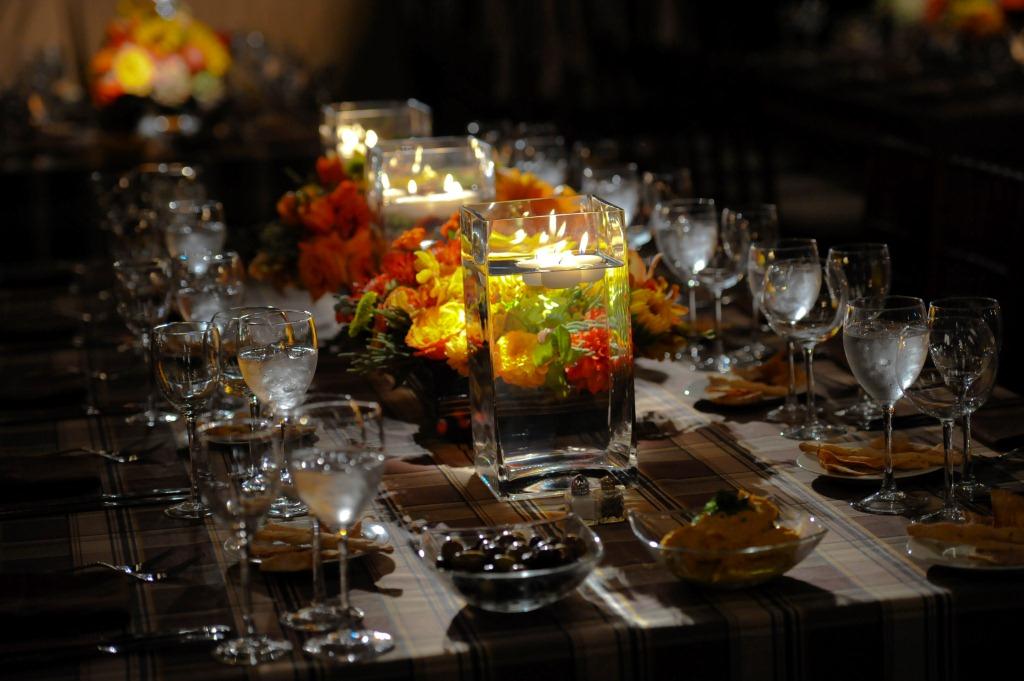 rectangular dinner table with plaid linen and orange flowers by evantine design