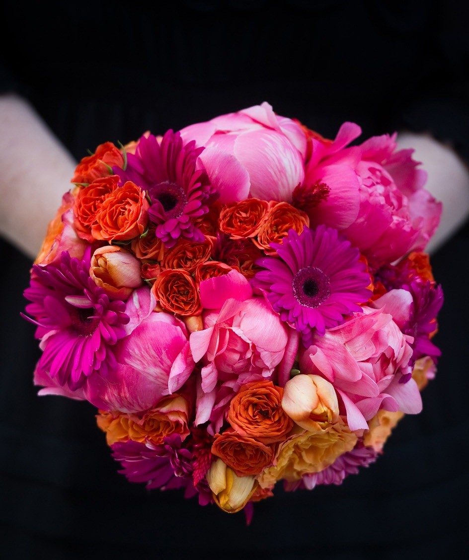 bridal bouquet with orange and hot pink flowers evantine cliff mautner