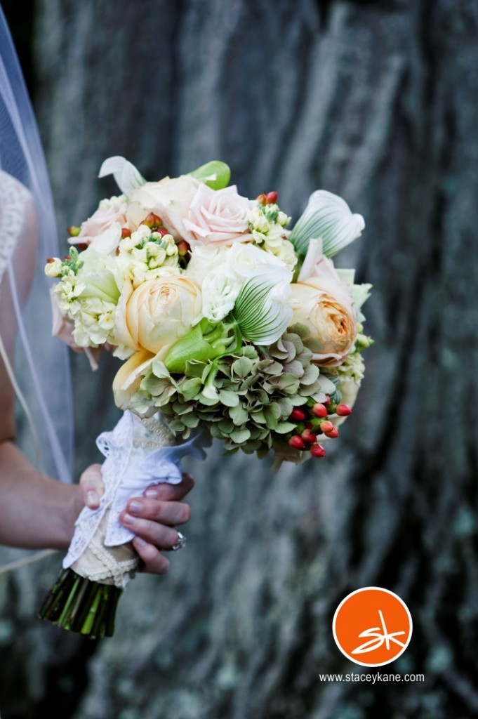 summer bridal bouquet with mixed flowers lady slipper orchids garden roses hypericum berry green hydrangea butter stock green parrot tulips