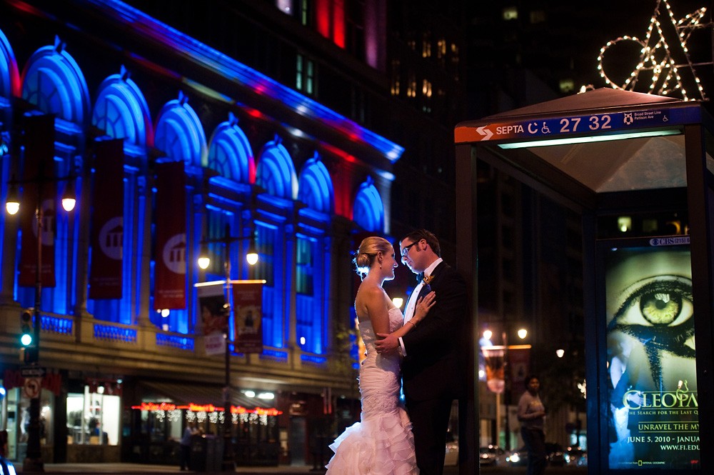 bride and groom city photos against the nightscape in Philadelphia