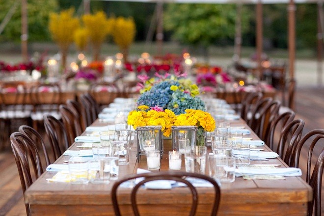 Blue Hydrangea yellow zinnias wooden feast tables sailcloth tented weddings