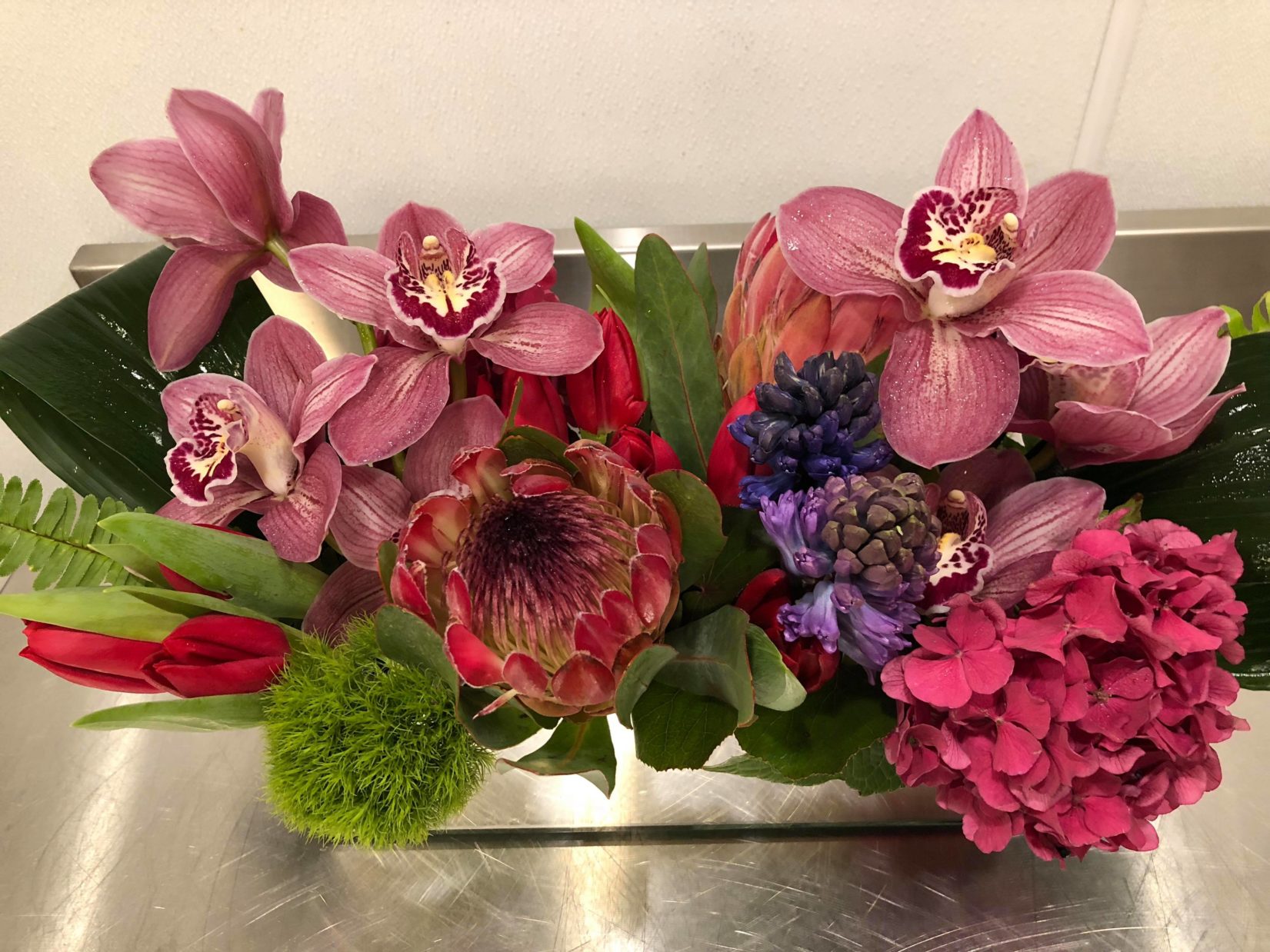 pink orchids hydrangea purple orchids king protea valentines day flowers evantine design